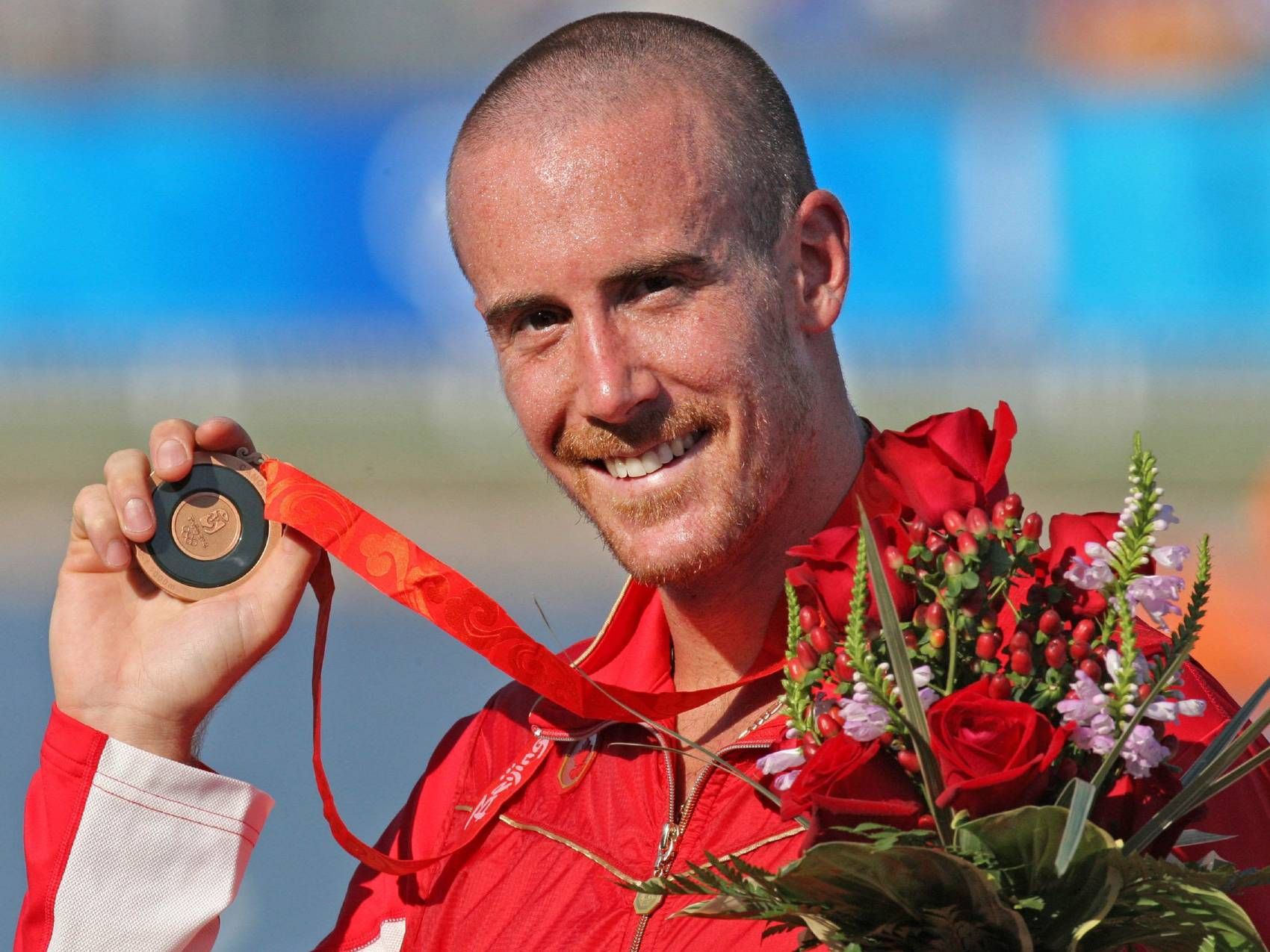 Canadian canoe paddler Thomas Hall holds up his bronze medal in the men's C-1 1000 meter race during the Olympic Games in Beijing on Aug. 22, 2008.