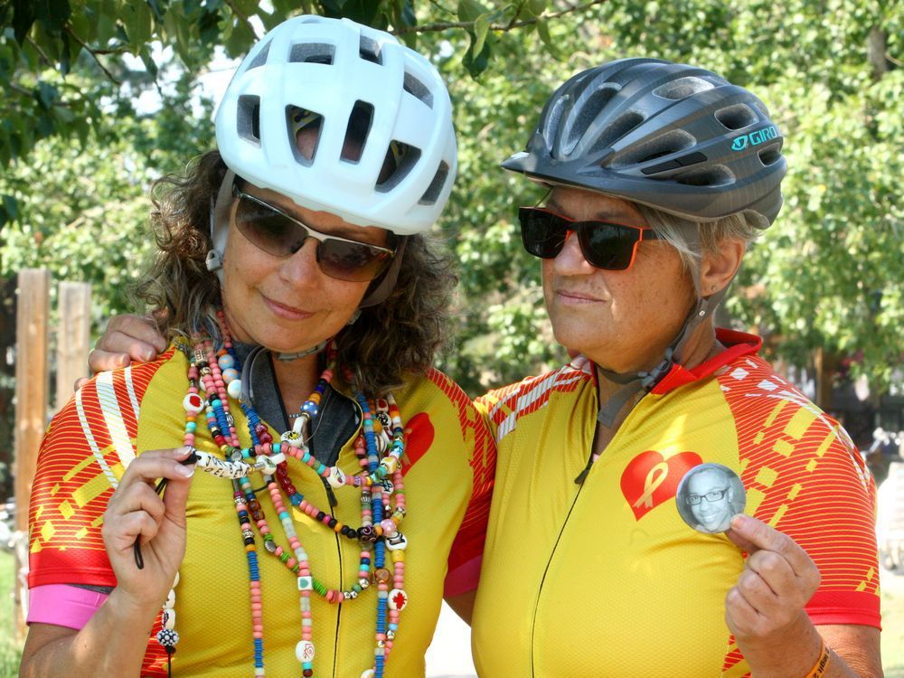 dale zukowski and anne cameron pose for a photo on the bow river pathway prior to an upcoming fundraiser. the bereaved parents of cancer victims doing a bike fundraiser for cancer research and plan to cycle from banff to lake louise tomorrow. saturday, july 17, 2021. brendan miller/postmedia