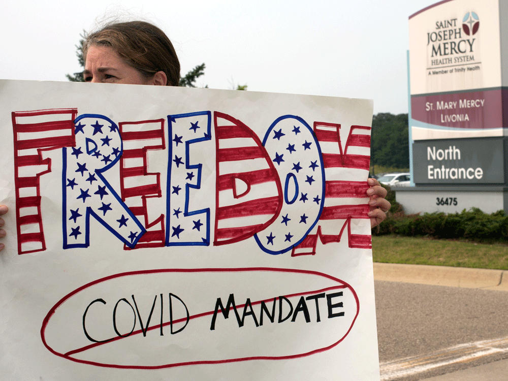 a protest against mandatory covid-19 vaccinations for healthcare workers in front of a hospital in livonia, michigan, on july 24, 2021.