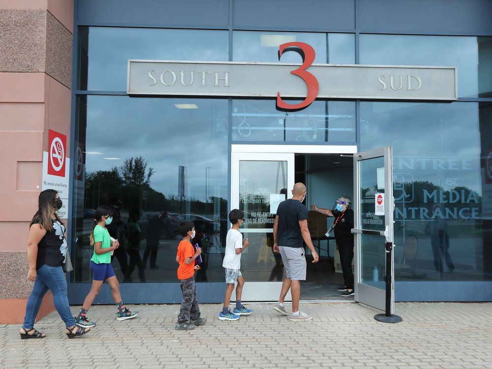 people lline up to receive a vaccine at the canadian tire centre