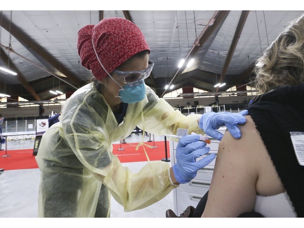 dr. tina kerelska vaccinates people at downsview arena on april 21, 2021.