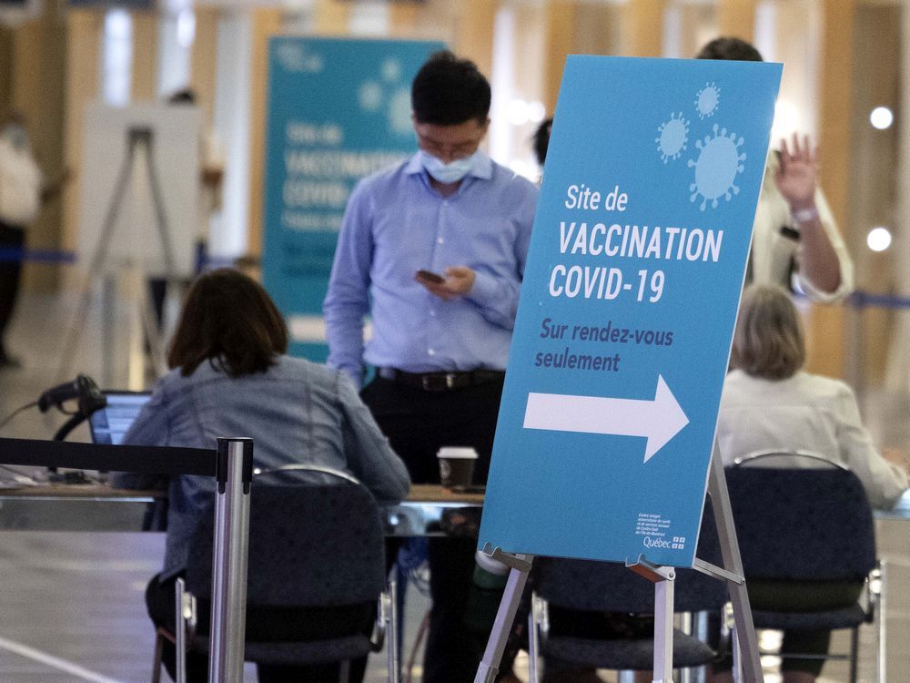 people register for the covid-19 vaccination at montreal's palais des congrès.