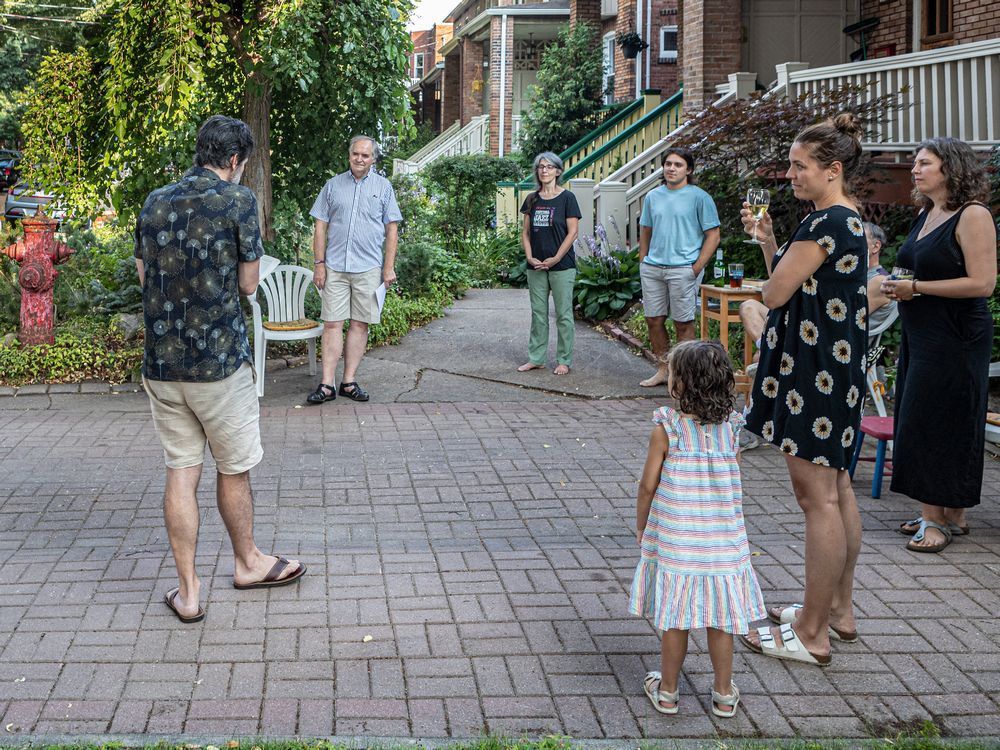 in the early days of the pandemic, william bukowski reached out to his neighbours to say he would be in the middle of their n.d.g. street in the evening of april 1, 2020, reading a short story by anton chekhov "and then maybe afterward we can have a chat.” the gatherings have become a weekly event. here, gregory saumier-finch (with back to camera) reads an essay by umberto eco called how to speak of animals.