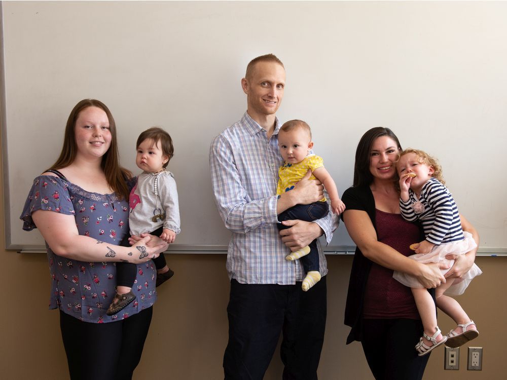 From left, Logan Badley and her child Havyn Badley, Tyler Seminuk and his child Mary-Jo Seminuk, and Jean Rice and her child Victoria Watkin all stand together for a photo in the Drug Treatment Court building in Regina on Aug. 25, 2021.