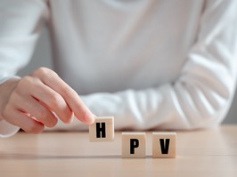 HPV (Human Papillomavirus) acronym on wood block, Asian woman holding wooden block, viruses Some strains infect genitals and can cause cervical cancer. Women health concept.