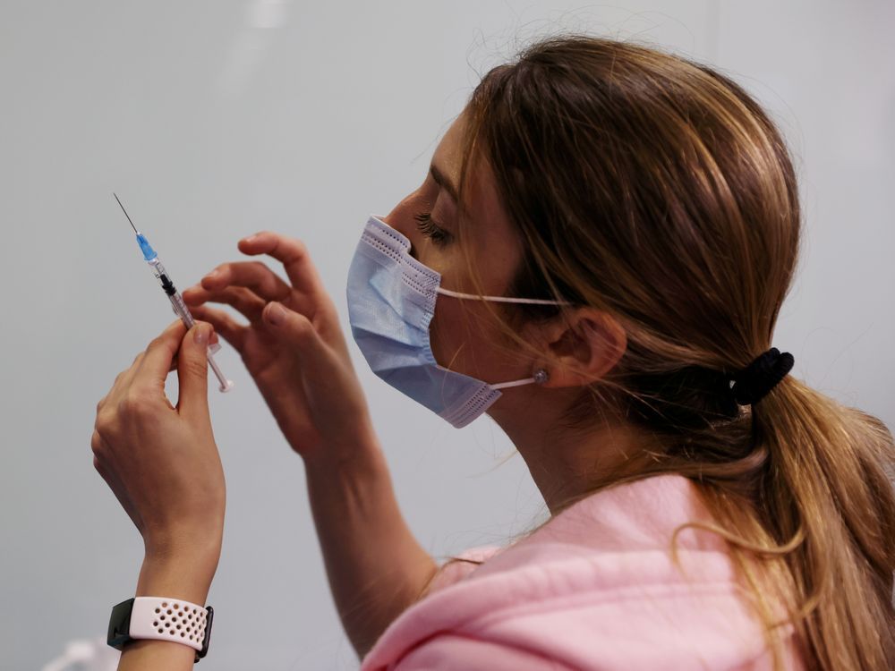 file photo: a medical worker prepares to administer a vaccination against the coronavirus disease.