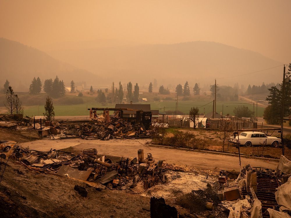 Thick smoke fills the air and nearly blocks out the sun as a property destroyed by the White Rock Lake wildfire is seen in Monte Lake, east of Kamloops.