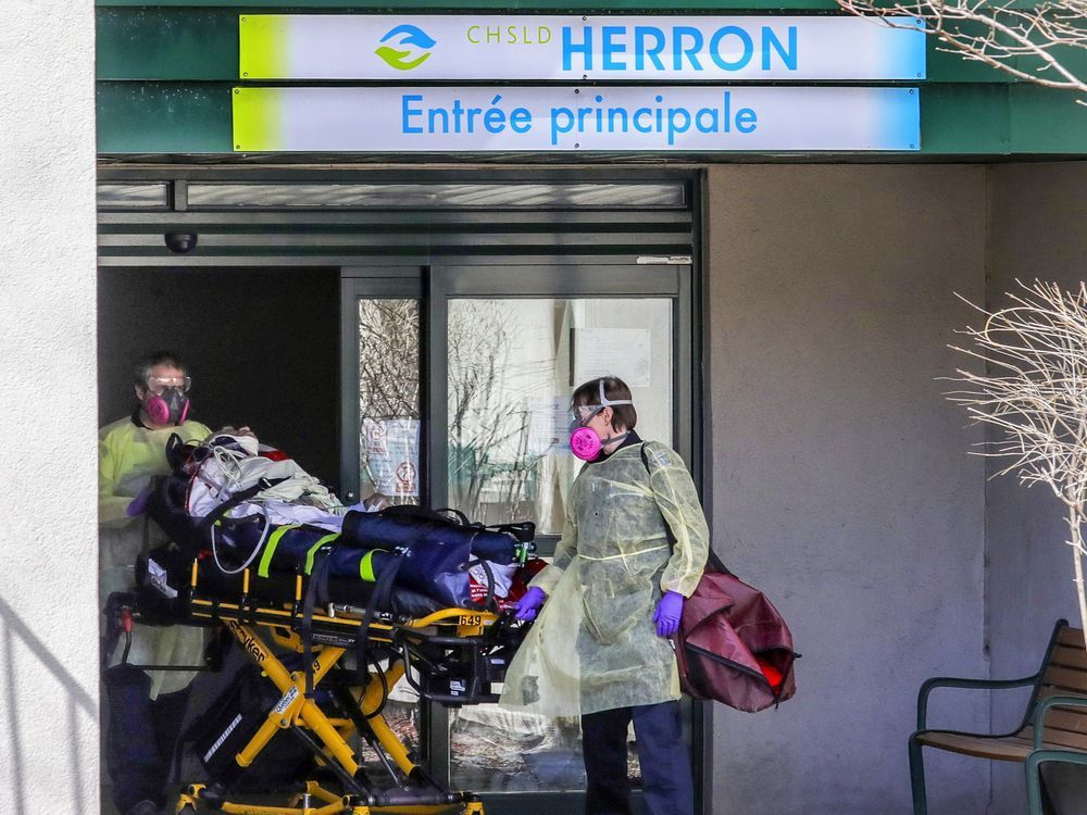 paramedics wheel a resident out of chsld herron in dorval on april 8, 2020.