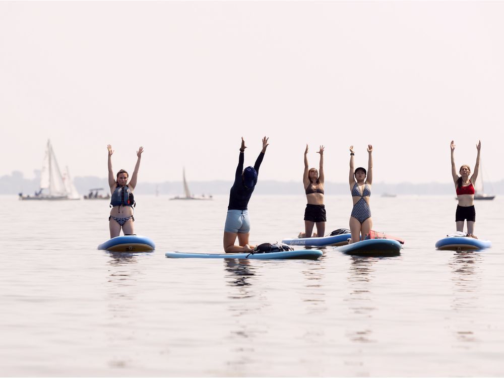 Members of Pop Spirit do paddle board yoga off the shore of Pointe Claire. An overwhelming amount of evidence endorses physical activity as a mood enhancer.