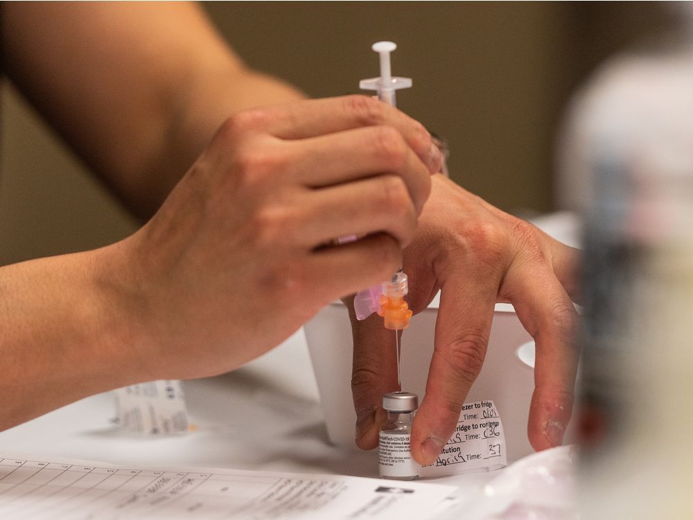 A nurse draws a dose of Pfizer-BioNTech vaccine at the Saskatoon Tribal Council (STC) COVID-19 vaccine clinic in the Sasktel Centre in Saskatoon, SK on Friday, April 9, 2021.