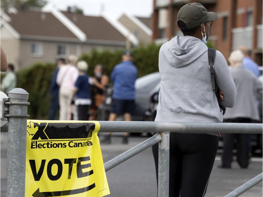 people wait in a long line to cast and early ballot in montreal, on friday, september 10, 2021.