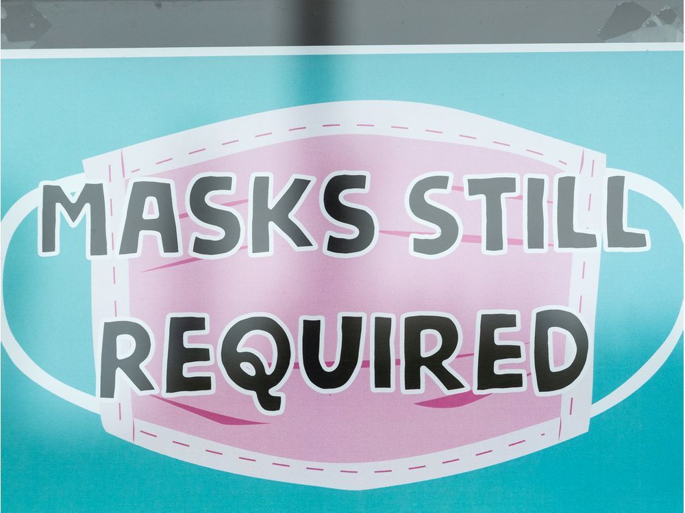 a sign reading "masks still required" is seen at the majesty and friends store in edmonton, on monday, aug. 30, 2021. edmonton's indoor public places mask mandate will be reinstated on friday, sept. 3 after a council vote.