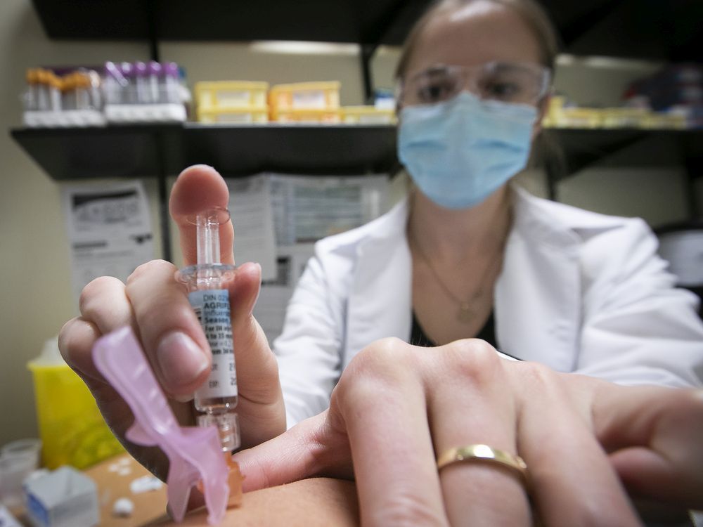 Nurse Jessica Mann Bourgouin administers a flu shot in October 2020.