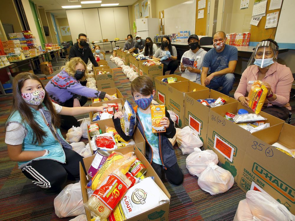 volunteers and families fill food hampers in calgary on wednesday, december 30, 2020.