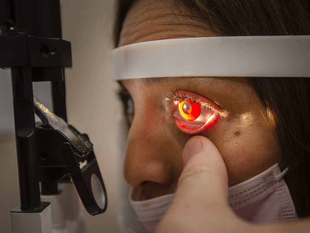 A costume contact lens can be seen on assistant Mariana Carruthers, at Orbit Contact Lens on Thursday, Oct. 28, 2021.