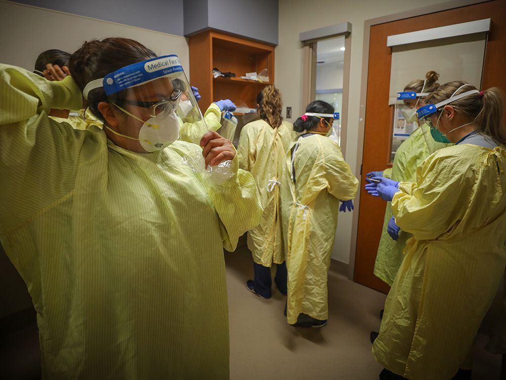 nurses prepare to treat a covid-19 patient on the intensive-care unit at peter lougheed centre in calgary on nov. 14, 2020.