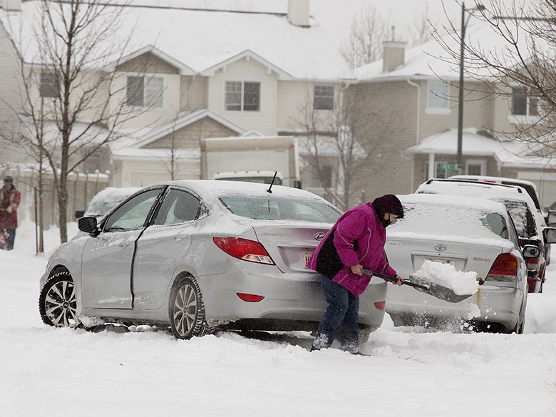 A motorist digs out their vehicle near 34 Avenue and Tamarack Green, in Edmonton on Tuesday Nov. 16, 2021, during a week when emergency calls for chest pain and cardiac arrest reached their highest level since the first week of October, according to AHS data.