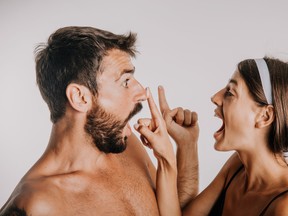 man and woman putting cream on their faces