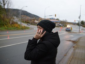 Bekky Meier, a dairy farmer talks to her husband on the phone as he works to save their farm, and keep their 250+ cattle healthy and alive in the Sumas Prairie, which is currently flooded, in the Sumas area of Abbotsford, British Columbia south of a closed Hwy 1, on November 18, 2021. - Rail and highway links to Vancouver were briefly reopened by emergency crews clearing debris, allowing travellers stranded by mudslides from record rainfall to pass in western Canada.