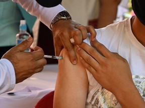 A student receives a dose of the Pfizer-BioNTech vaccine.