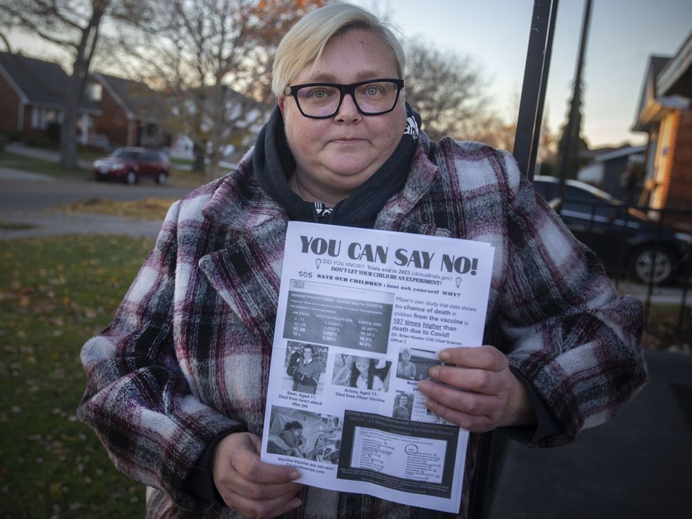 bronwyn greenacre holds an anti-vaccine flyer she received outside her children's school, on tuesday, nov. 23, 2021.