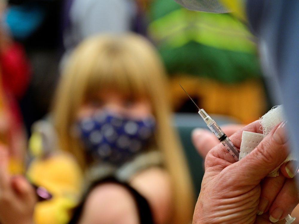 a syringe is seen as a child receives a dose of the pfizer-biontech coronavirus disease (covid-19) vaccine at smoketown family wellness center in louisville, kentucky, u.s., november 8, 2021. reuters/jon cherry