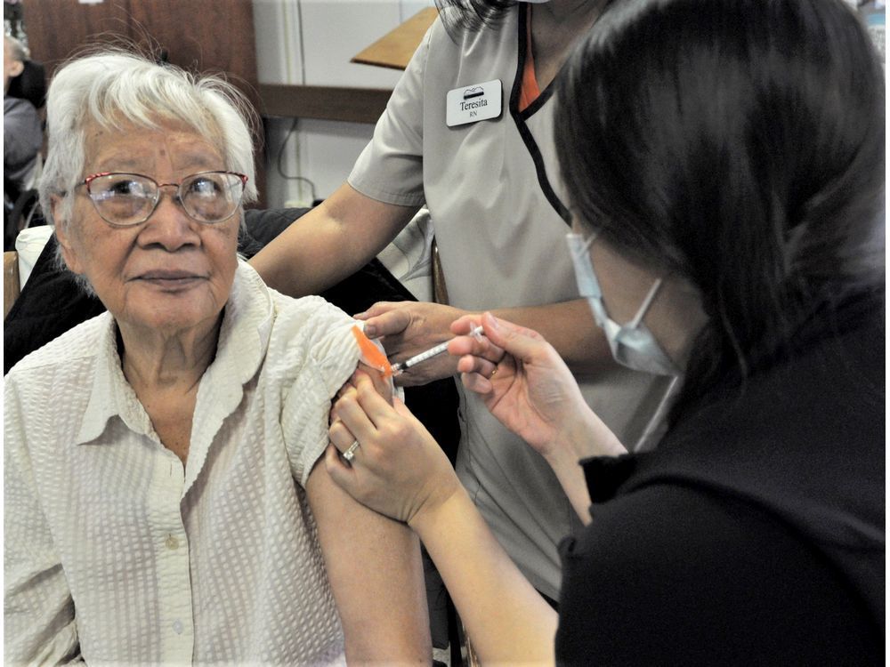 dogwood lodge resident magdalena bakar getting her covid-19 pfizer booster shot from registered nurse serena soo on oct. 27.