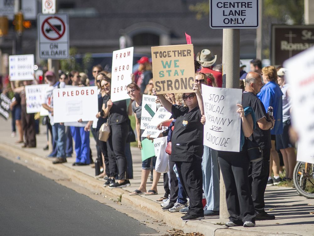 protesters demanding an end to vaccine mandates hold a rally across the street from windsor regional hospital - met campus, on wednesday, sept. 29, 2021.