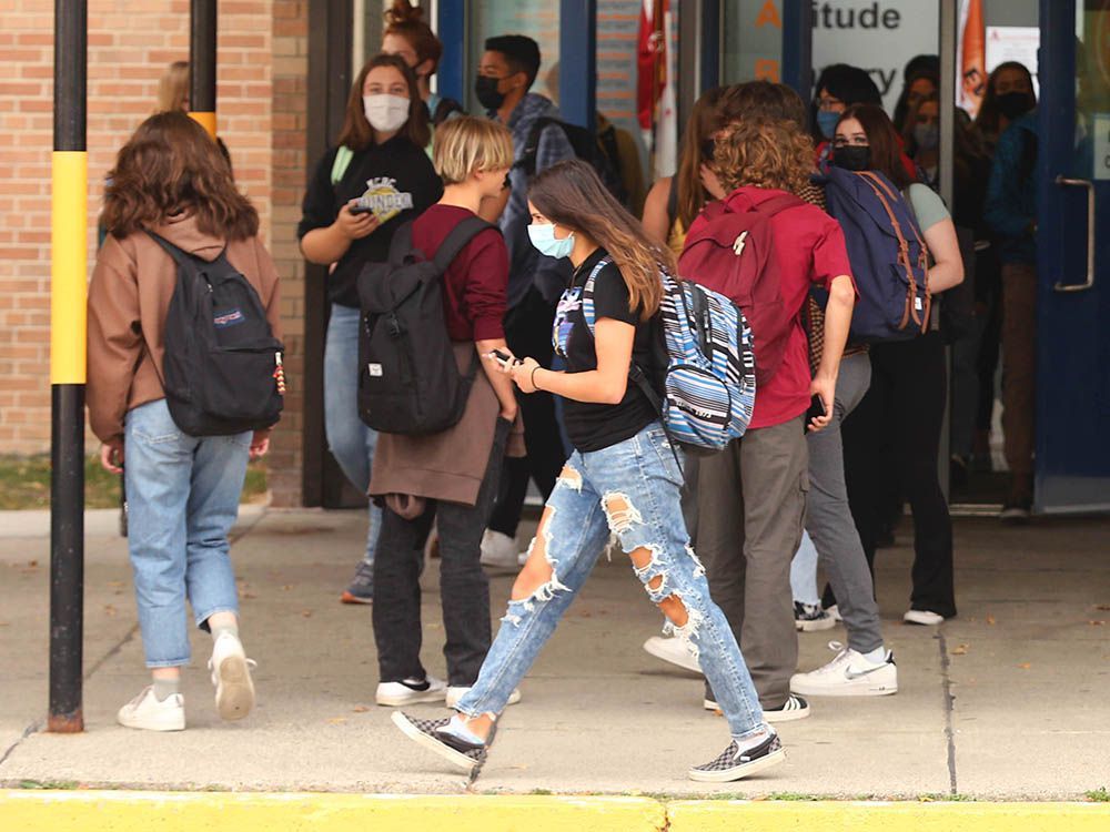 students, most of them wearing masks, leave william aberhart high school at the end of the day in northwest calgary on oct. 5, 2021.