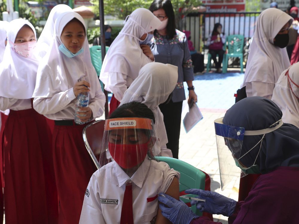 Health workers administer HPV vaccines to elementary school students in Jakarta, Indonesia. Vaccines are much less resource-intensive than a strategy that requires regular testing and follow-up, notes Christopher Labos.