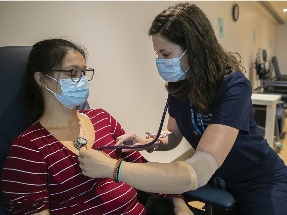 lakeshore general hospital emergency physician dr. vanessa knight (right) meets with patient line daviault. knight was born with one hand and despite everything, she is able to perform her job with dexterity.