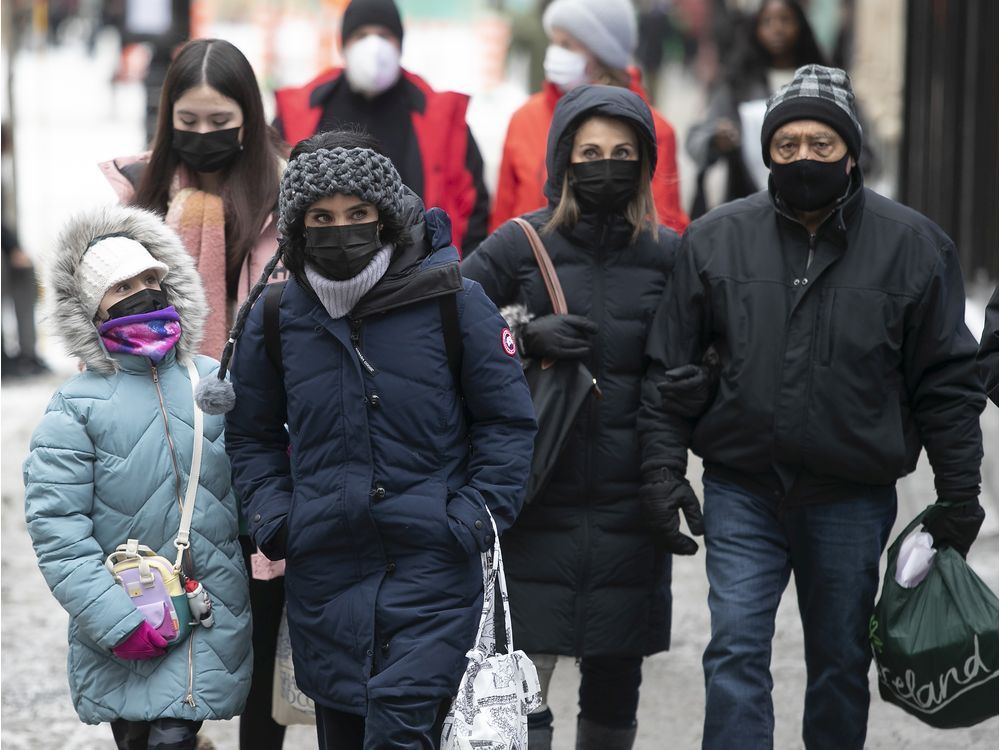 people walk along ste-catherine st. in montreal after health minister christian dubé announced further covid-19 restrictions.