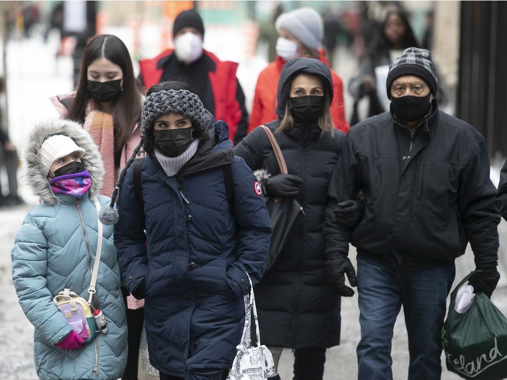 people walk down ste-catherine st. downtown on monday dec. 20, 2021.