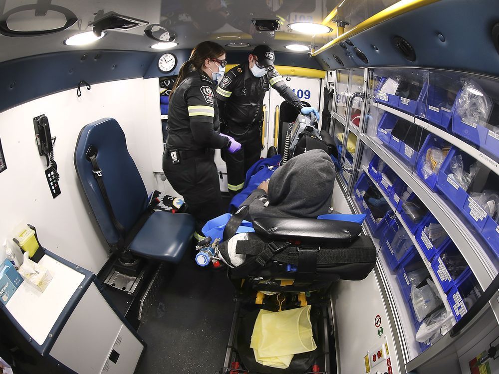 essex-windsor ems paramedics katie rawlings and mike sherwood care for a man in the back of an ambulance on saturday, november 13, 2021.