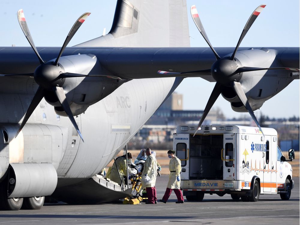 medical personnel load a patient onto a royal canadian air force cc-130j hercules transport aircraft in saskatoon after the province of saskatchewan said it would send covid patients from overloaded icu wards to ontario hospitals. reuters/liam richards