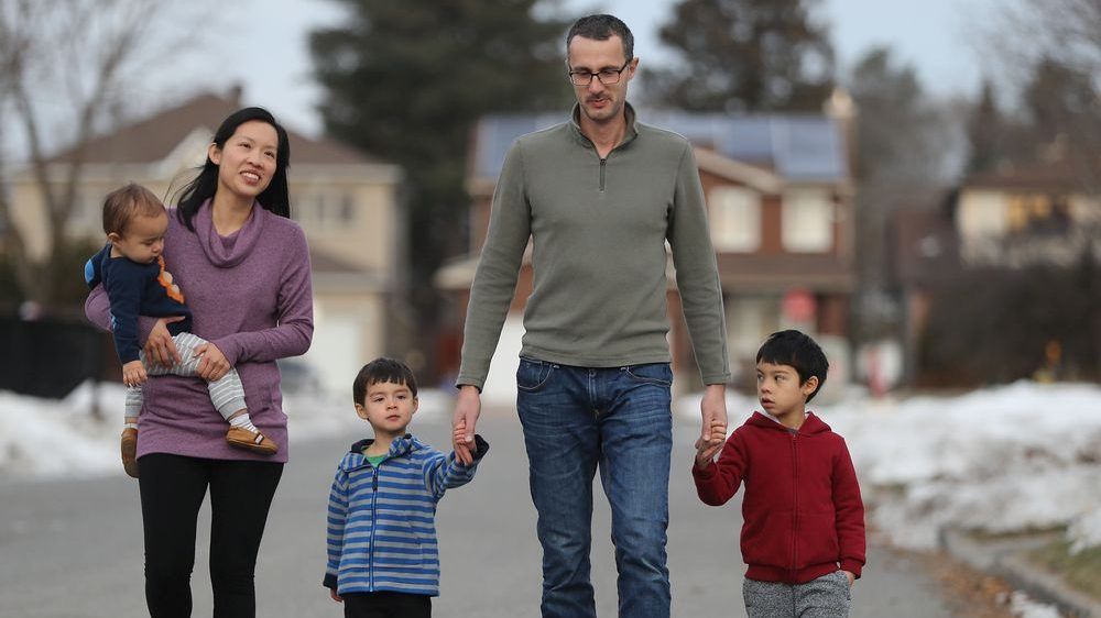 Dr. Winnie Siu with her husband Allan Reesor-McDowell and three kids Emerson (6), Owen (3) and Wesley (1) outside their Ottawa home. Winnie is a public health doctor who chose to take parental leave in the midst of the COVID crisis.