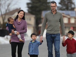 Dr. Winnie Siu with her husband Allan Reesor-McDowell and three kids Emerson (6), Owen (3) and Wesley (1) outside their Ottawa home. Winnie is a public health doctor who chose to take parental leave in the midst of the COVID crisis.