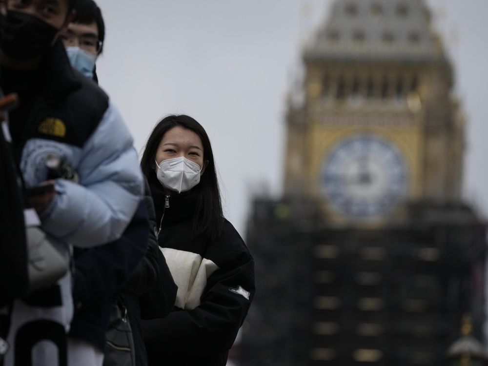 people queue to get a coronavirus booster jab at st thomas' hospital, backdropped by the scaffolded elizabeth tower, known as big ben, and the houses of parliament, in london, monday, dec. 13, 2021. long lines formed at vaccination centers in britain as people heeded the government's call for all adults to get booster shots to protect against the omicron variant of the coronavirus, which the prime minister said monday has caused at least one death.