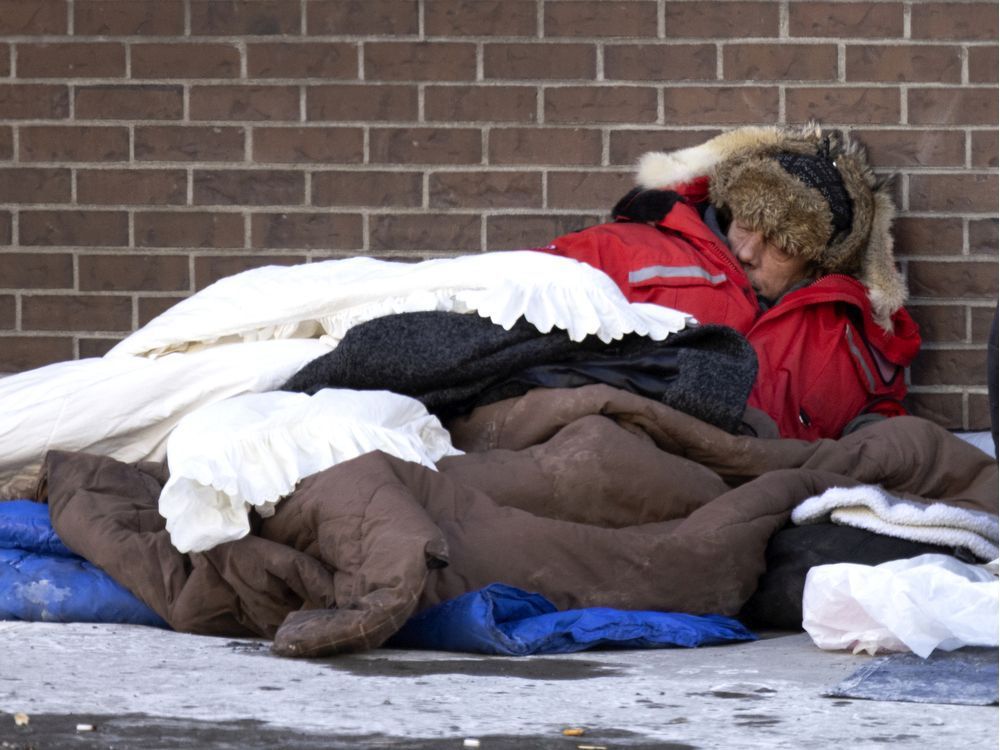 a man tries to find ways to stay warm as the city deals with a cold snap, in montreal, on sunday, jan. 16, 2022.