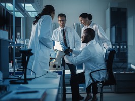 Medical Science Laboratory with Diverse Multi-Ethnic Team of Microbiology Scientists Have Meeting on Developing Drugs, Medicine, Doing Biotechnology Research. Working on Computers, Analyzing Samples