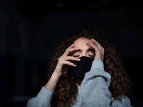 Portrait of depressed young woman indoors, covid-19 and mental health concept.