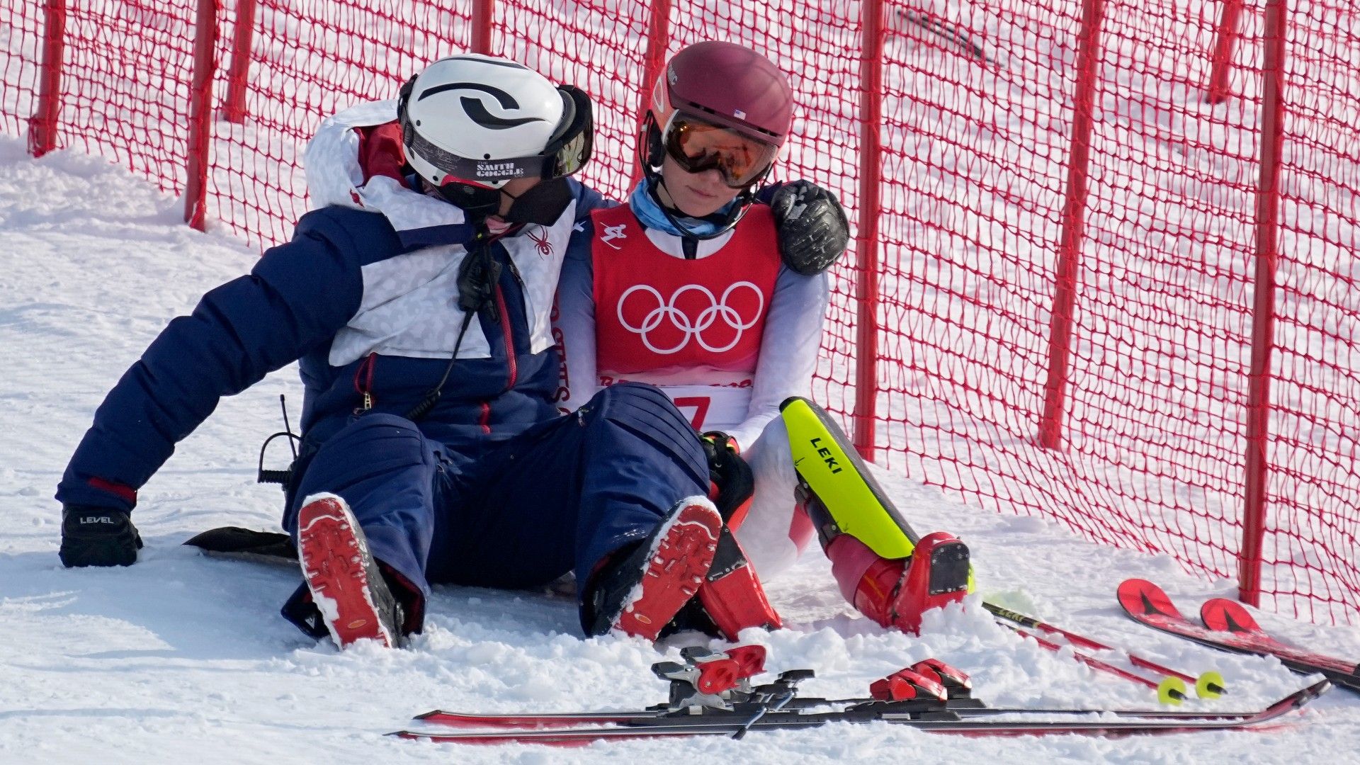 A teammate consoles skiier Mikaela Shiffrin after her fall during the slalom at the Beijing Olympics on Tuesday. (Robert F. Bukaty / AP)