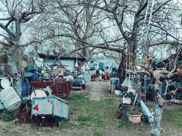 Hoarding disorder outdoors. Neglected allotment garden of people who suffers from compulsive hoarding, littered with trash and other items.