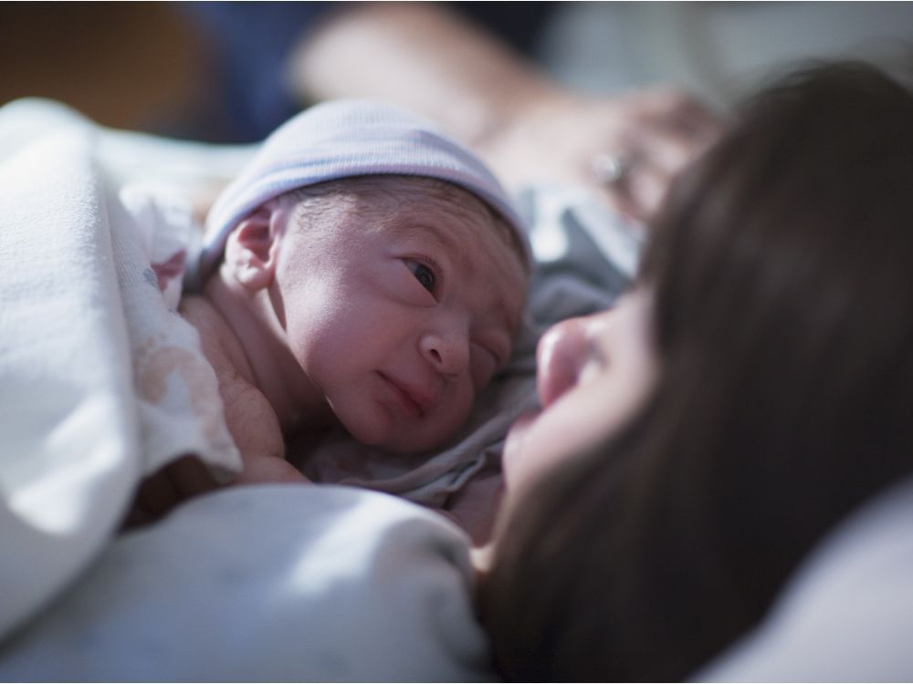 A newborn baby and his mom. Getty Images/iStock Photo.