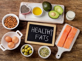 Selection of healthy fat sources on wooden background