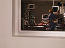 Nurse tending patient in intensive care