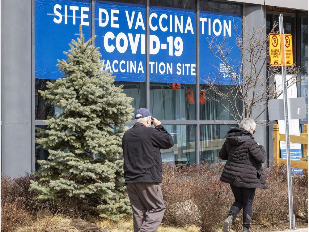 people walk past the covid-19 vaccination clinic on parc ave.