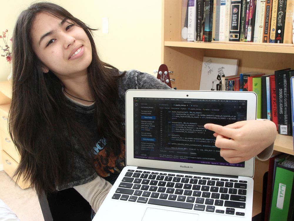 grade 9 student rachel simantov poses for a photo with her macbook in her southwest calgary home on april 17, 2022.