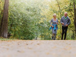 Smiling senior couple jogging in the park