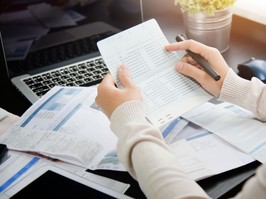 Person reviewing documents at desk